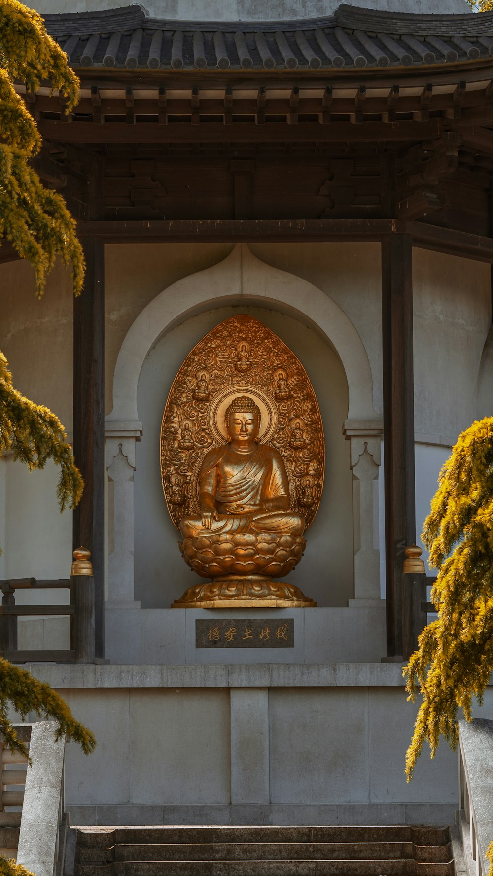gold buddha statue on gray concrete arch