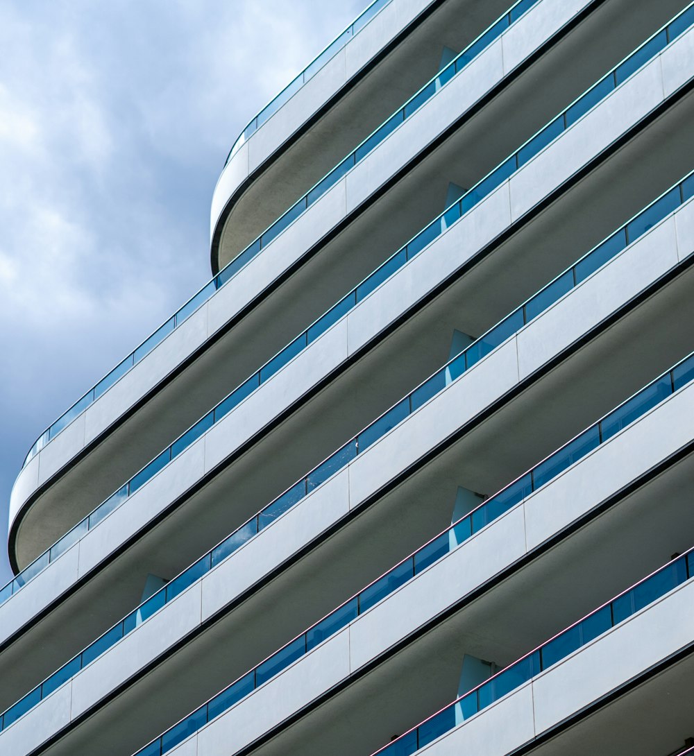 white and blue concrete building under white clouds during daytime