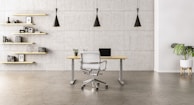 A sleek, minimalist wooden desk designed for a home office with natural light.