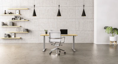 Modern minimalist office interior with white walls and natural wood desks.