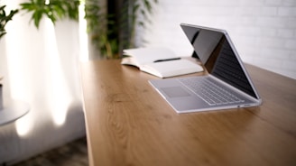macbook pro on brown wooden table