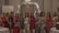 A group of women posing together while smiling, dressed in various elegant outfits. They are standing in a decorated indoor setting with balloons arranged in an arch behind them and tables with white tablecloths.