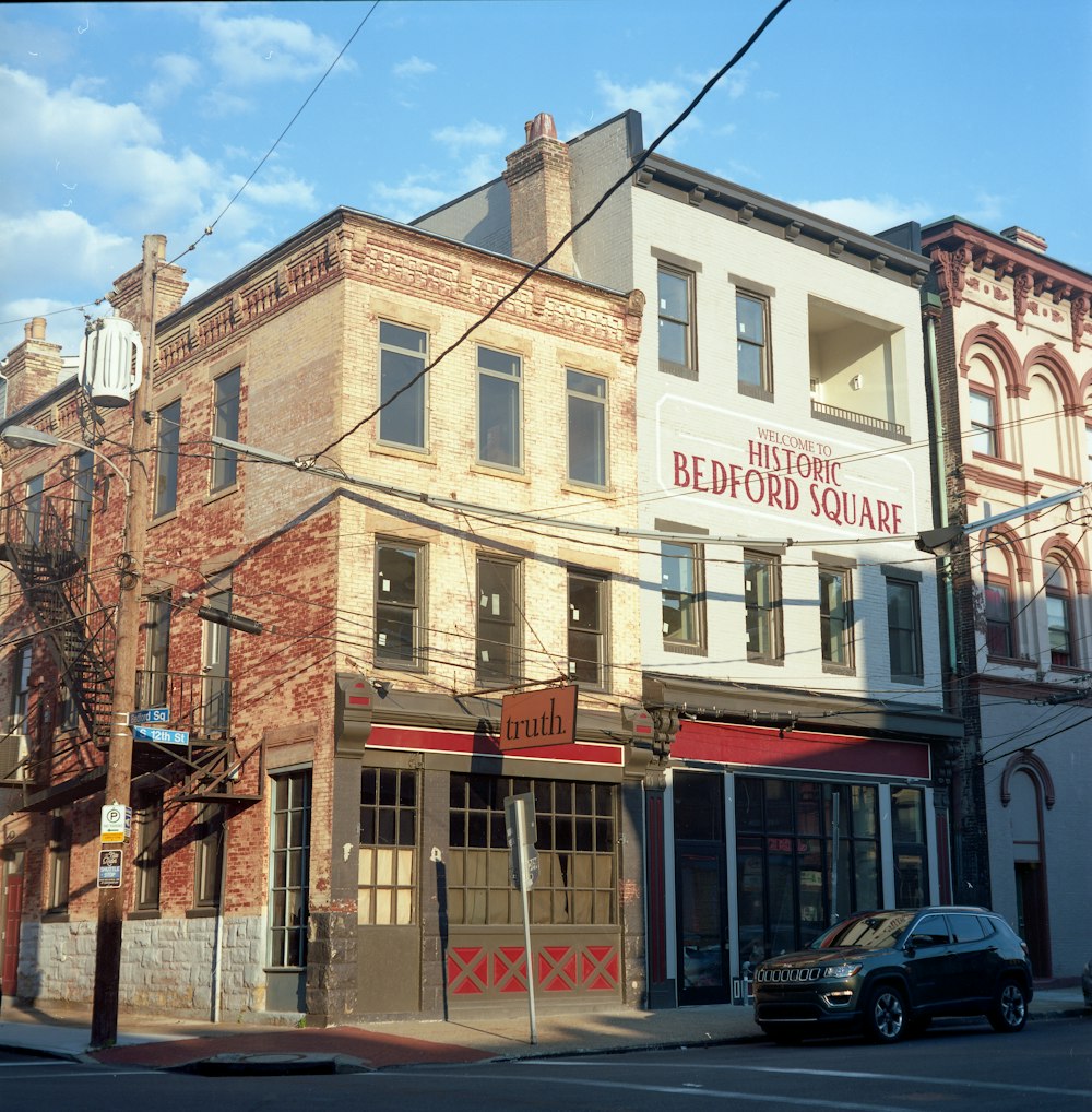 cars parked in front of brown concrete building during daytime