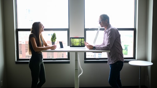A friendly consultant discussing risk management with a city official in an office.