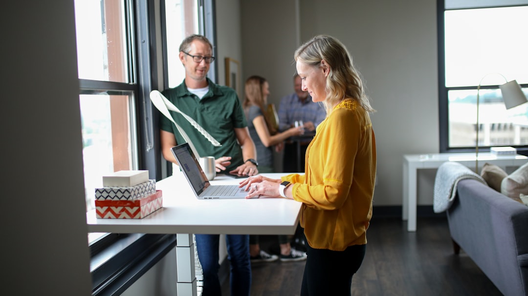 woman in yellow long sleeve shirt using macbook pro