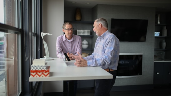 A calm office setting with a person attentively listening to another during a conversation.