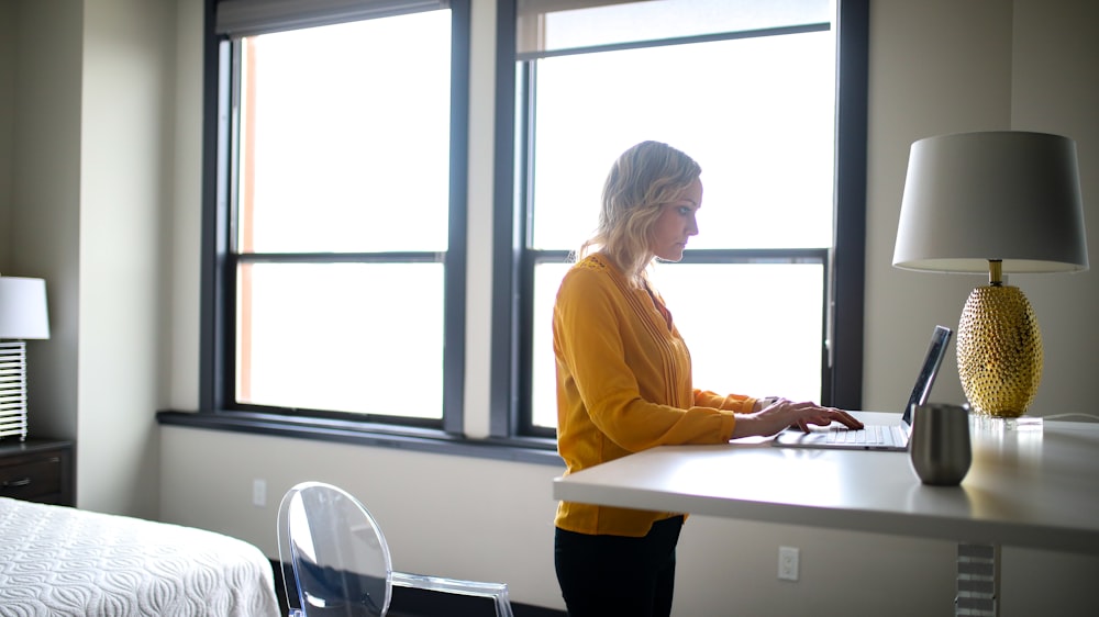 woman in yellow long sleeve shirt sitting on chair