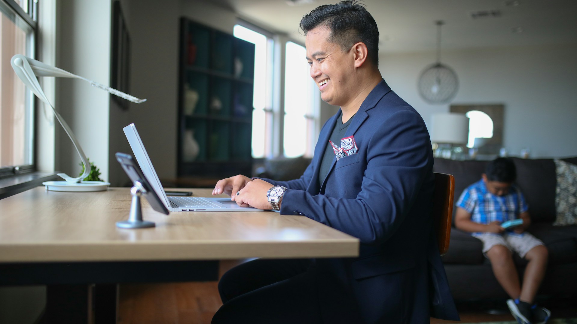 man in black suit jacket sitting at the table