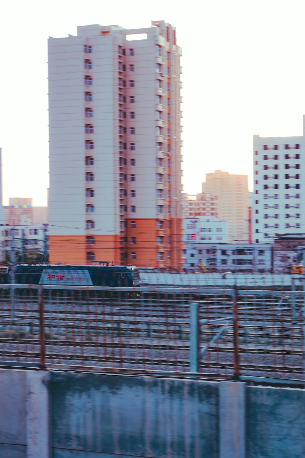 blue and white bus on road near high rise buildings during daytime