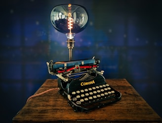 black typewriter on brown wooden table