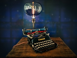 black typewriter on brown wooden table