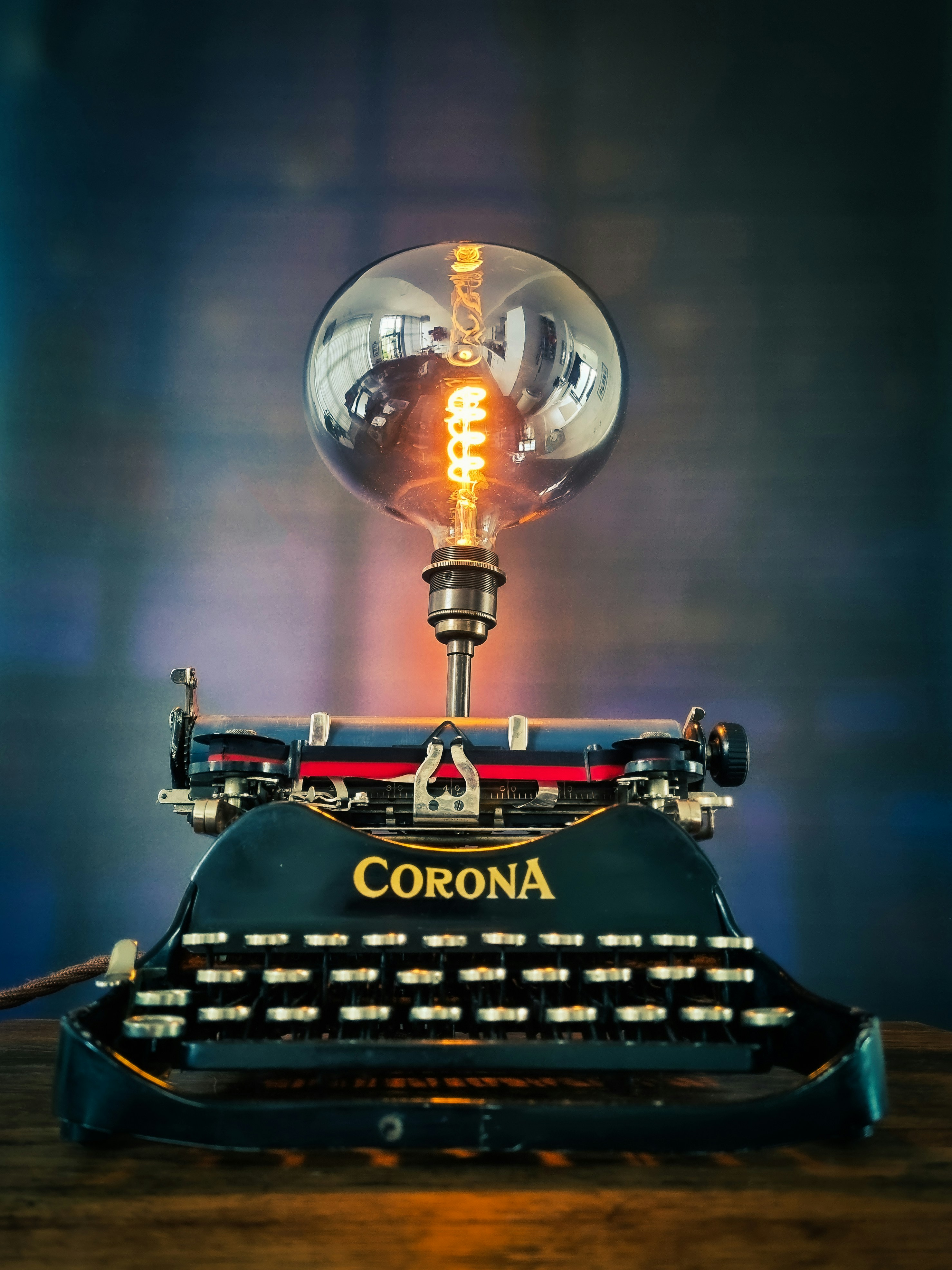 black and red typewriter on table