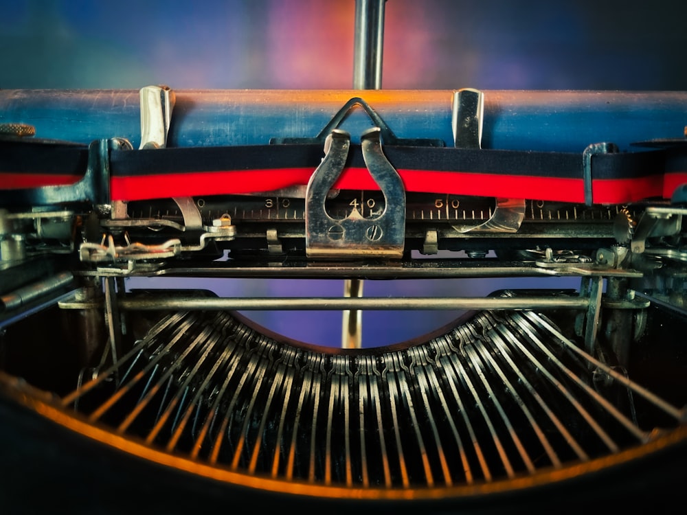 red and black typewriter on brown wooden table