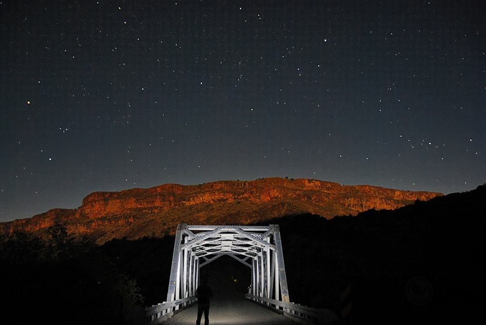 white bridge under starry night