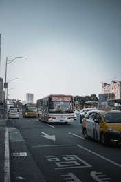 A busy road with various passenger transport vehicles.