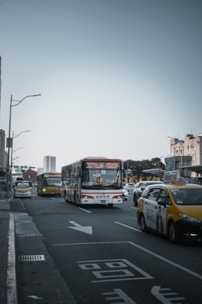 A busy road with various passenger transport vehicles.