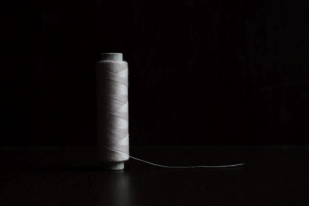 white thread on black table