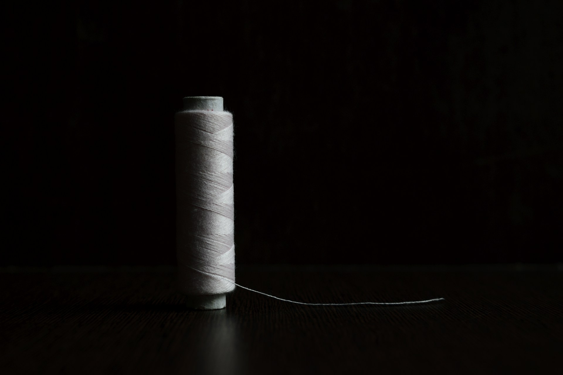 white thread on black table