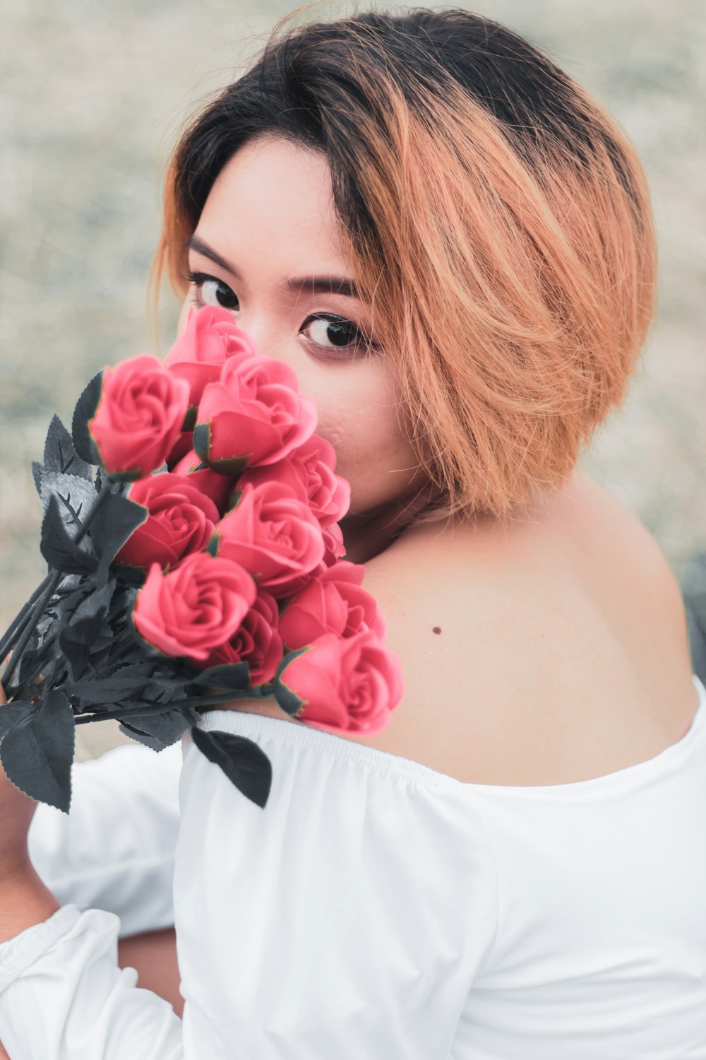 woman in white shirt with black and red floral headband