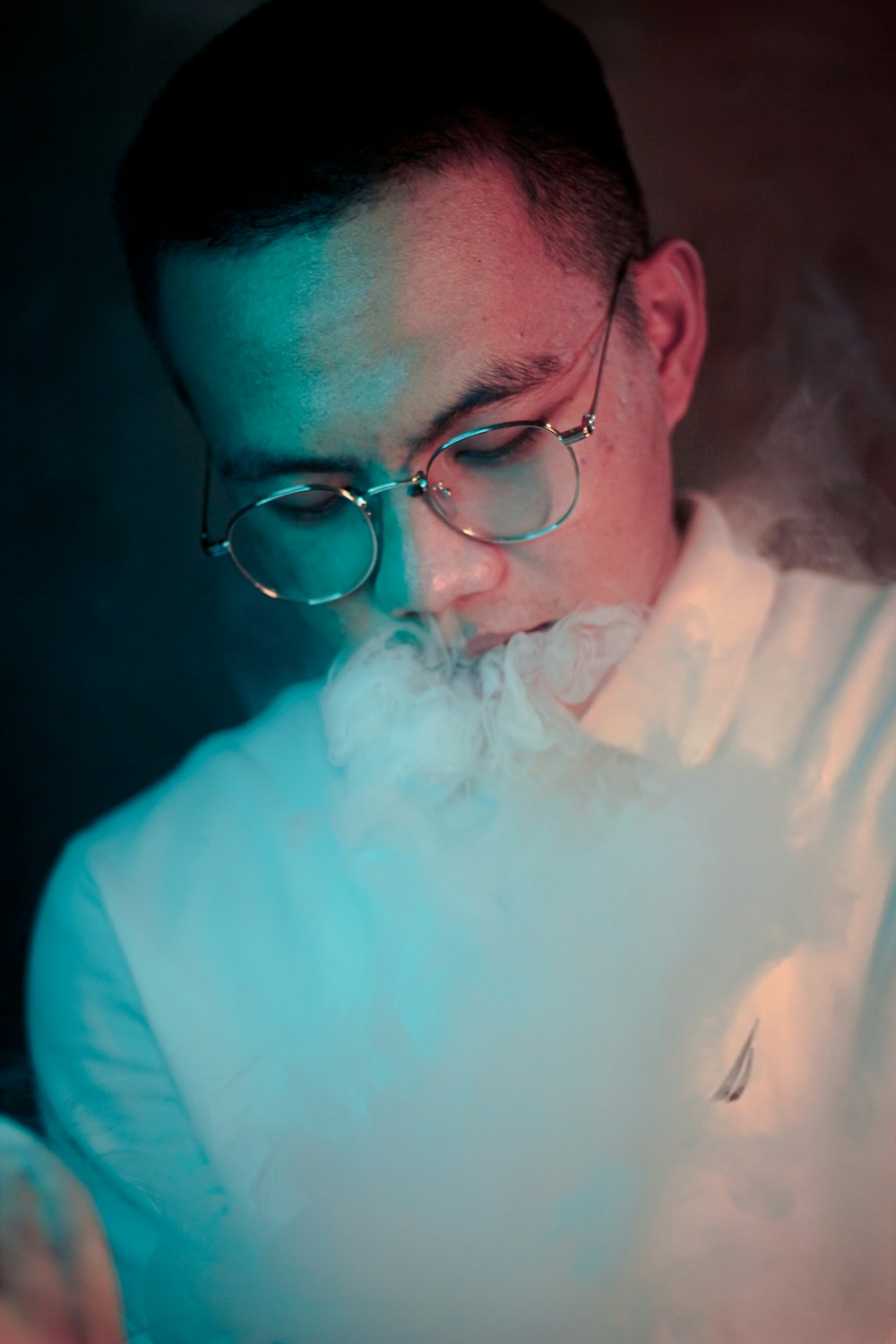 man in blue dress shirt wearing black framed eyeglasses