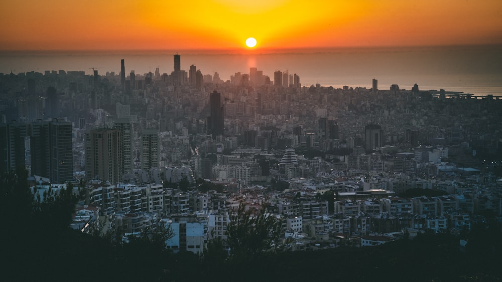 city skyline during sunset with orange sky