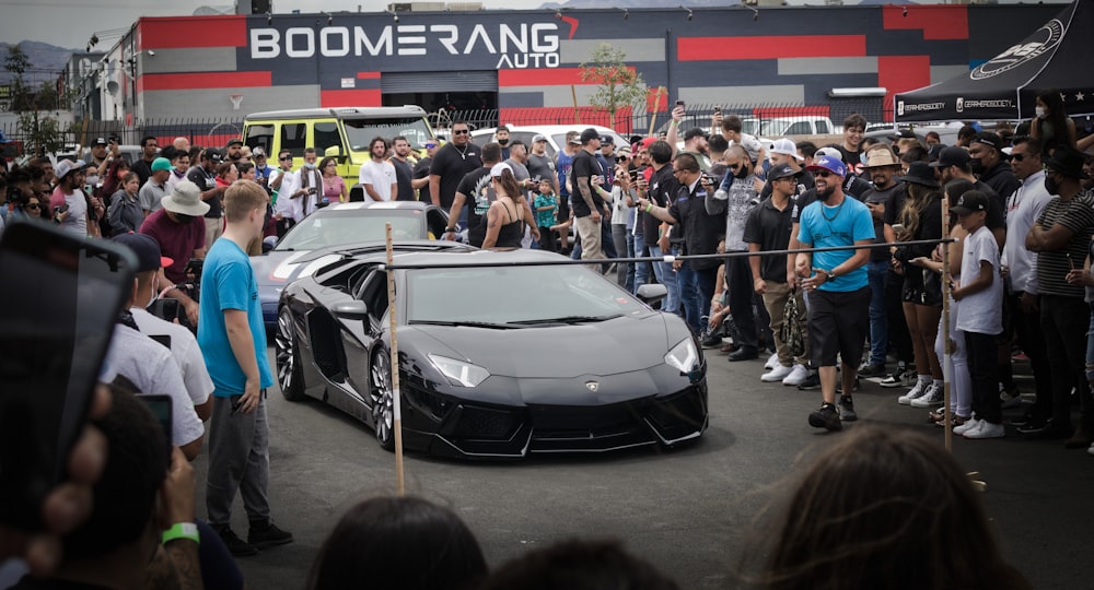 people standing near white and black car