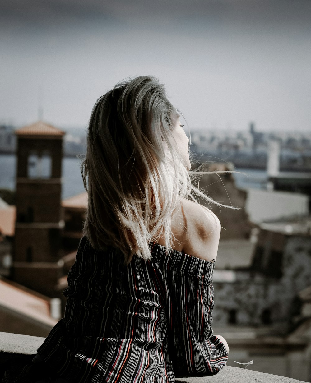 woman in black and white off shoulder dress