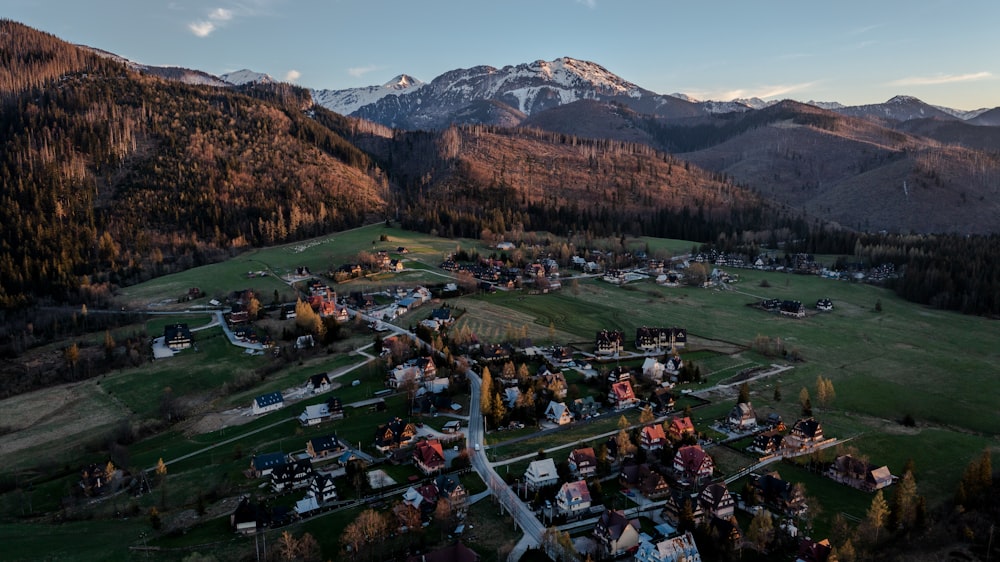 aerial view of green grass field near mountain during daytime