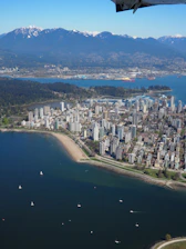aerial view of city buildings near body of water during daytime