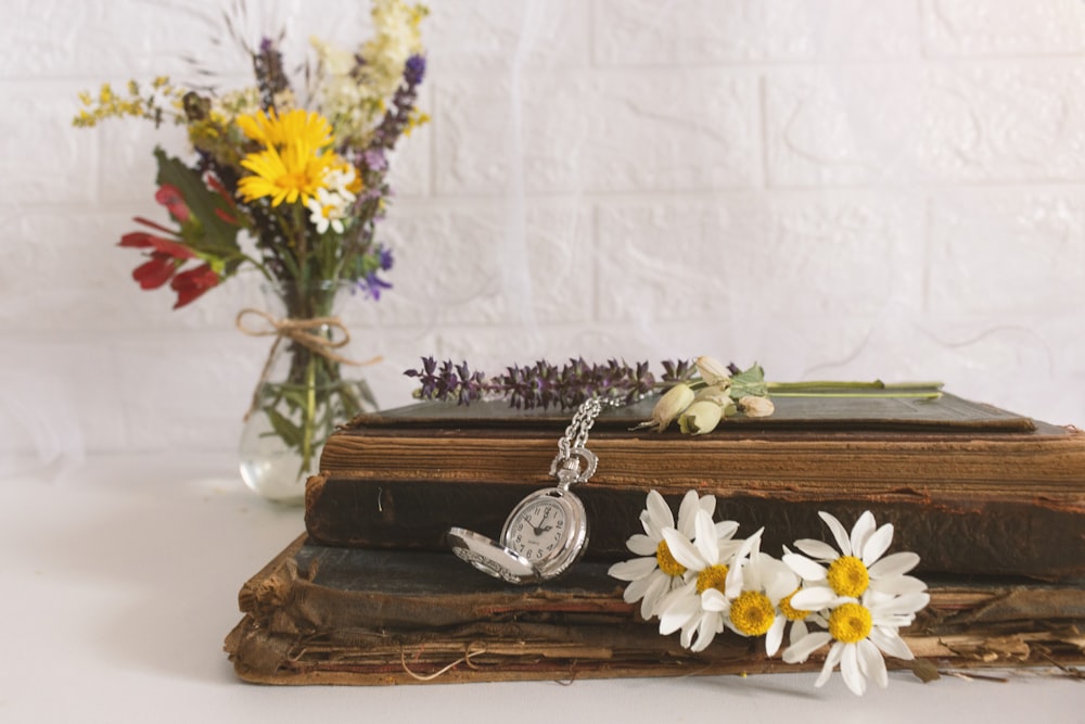 white and yellow flowers on brown wooden table