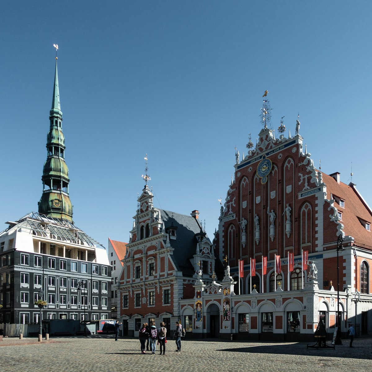Riga Old Town in wet October light with reflective cobbles