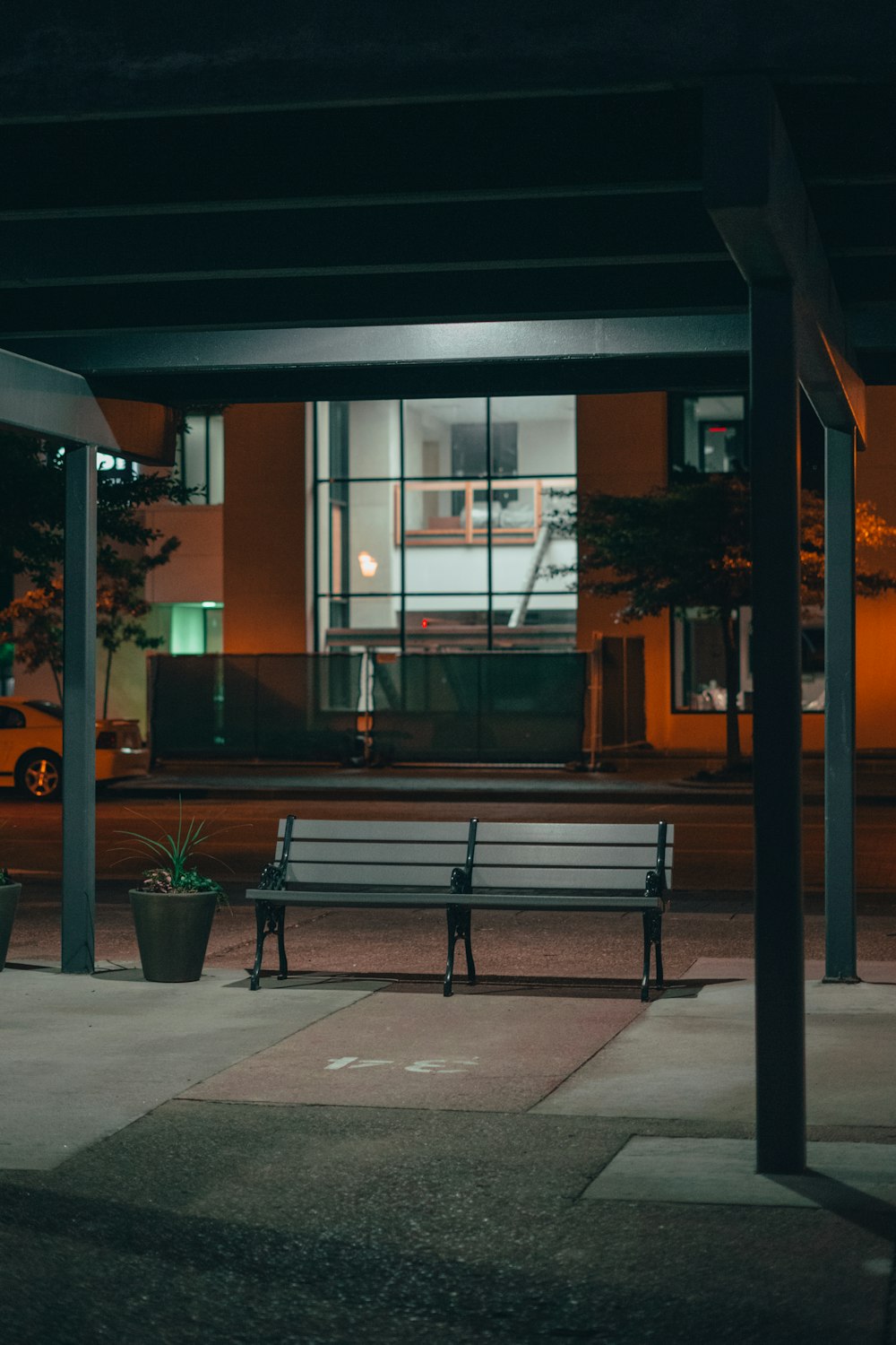 brown wooden bench near glass window