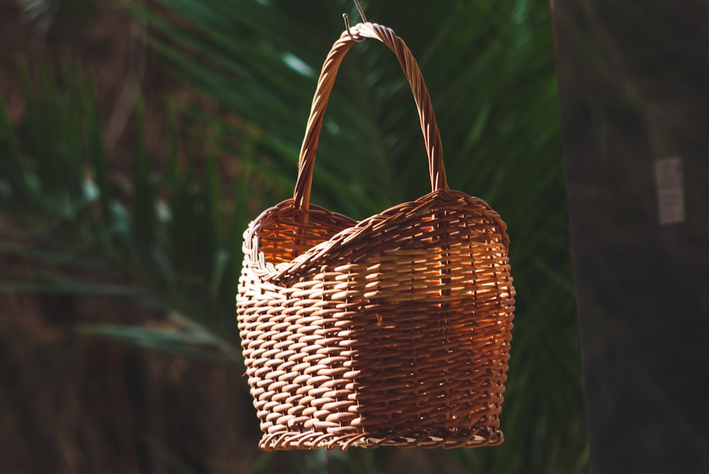 brown woven basket on green textile