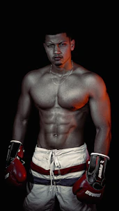 Moody studio shot of a muscular man lacing up his training gloves, surrounded by dark fitness gear.
