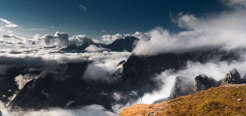 white clouds over mountain during daytime