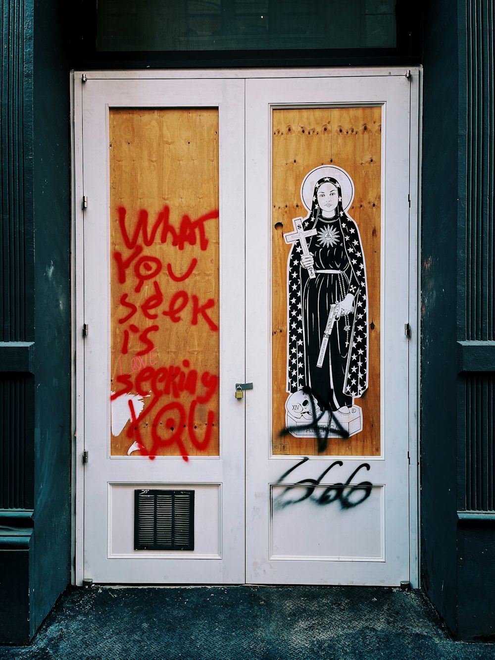 woman in black and white long sleeve dress standing in front of white wooden door