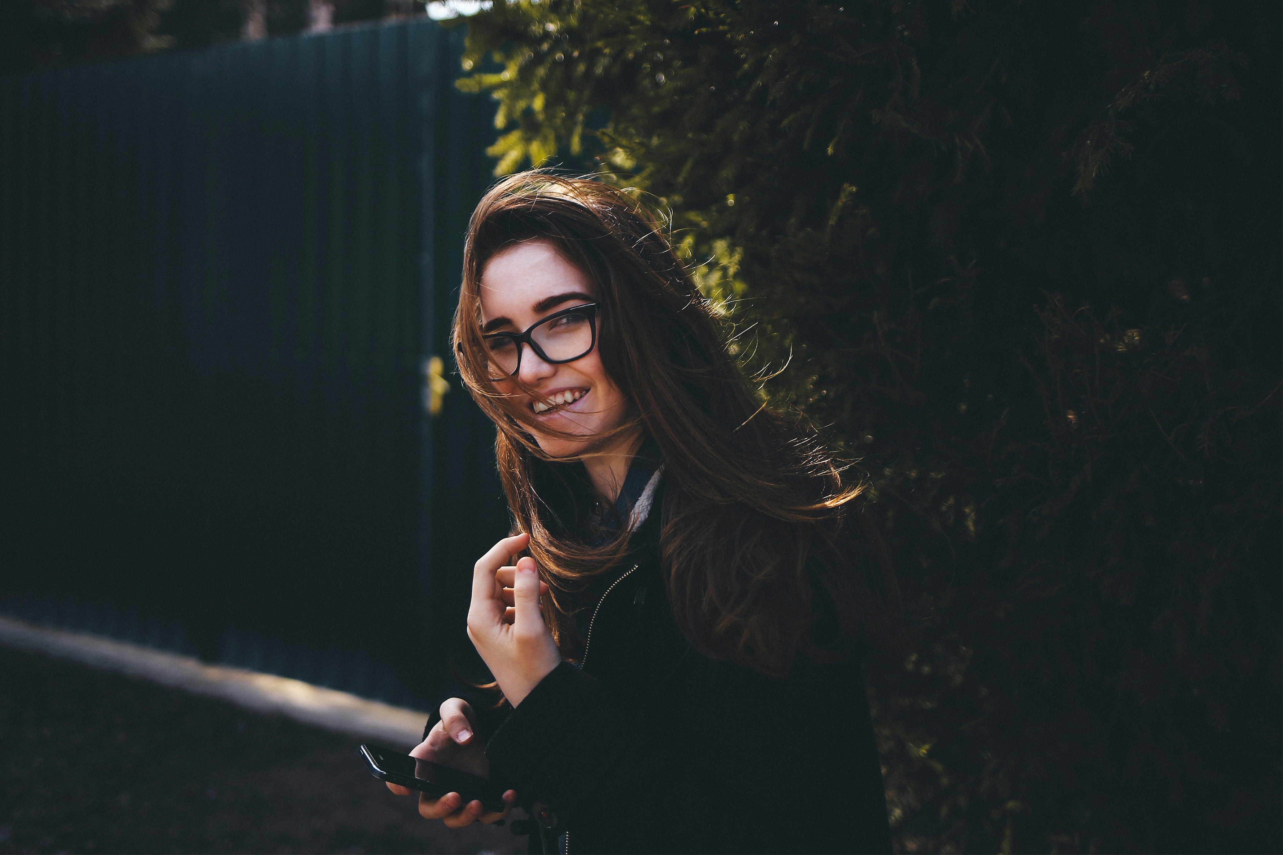 woman in black long sleeve shirt wearing black framed eyeglasses