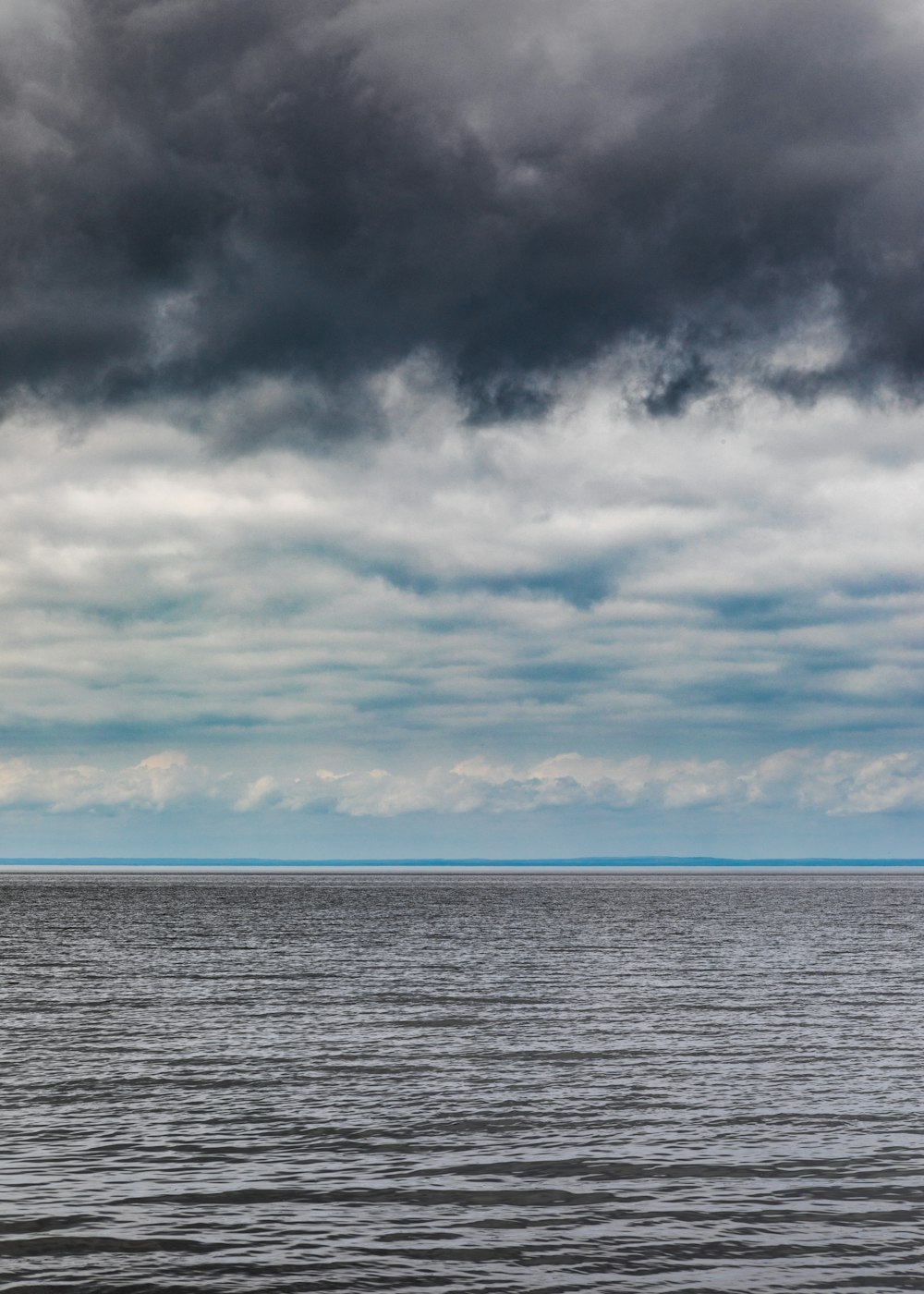 body of water under cloudy sky during daytime