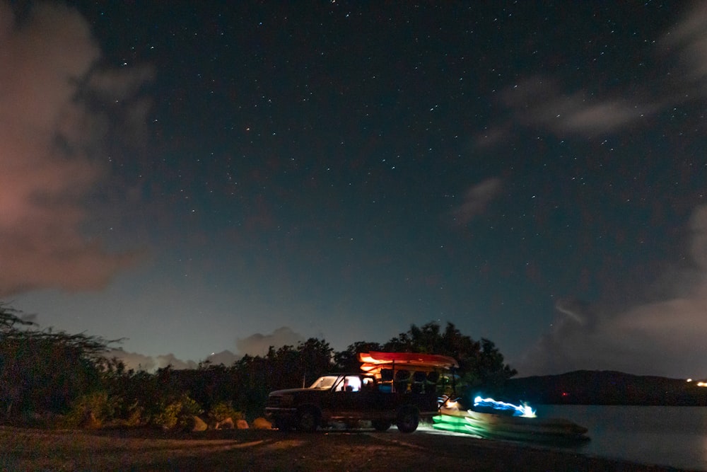 red and black bus on road during night time