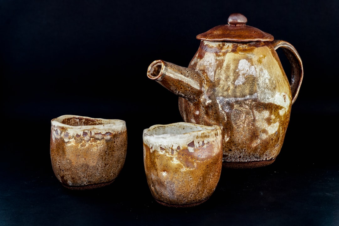 2 brown and white ceramic teapot