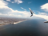 A scenic aerial shot of a coastal city taken during a flight