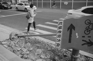 A traveler using a smartphone to translate Chinese characters on a street sign.