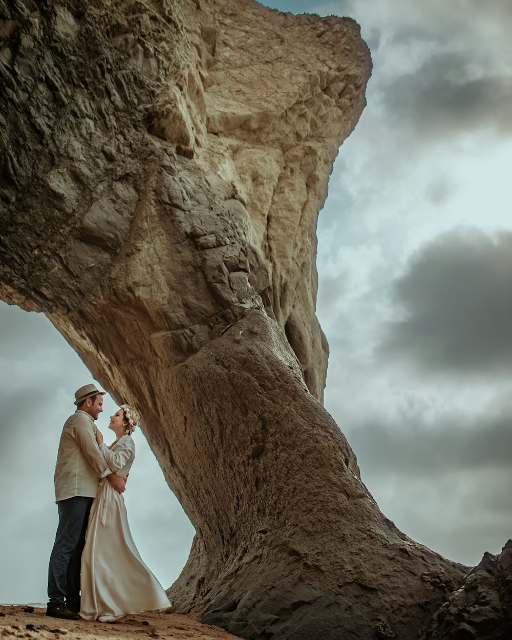 man and woman kissing on brown rock formation during daytime