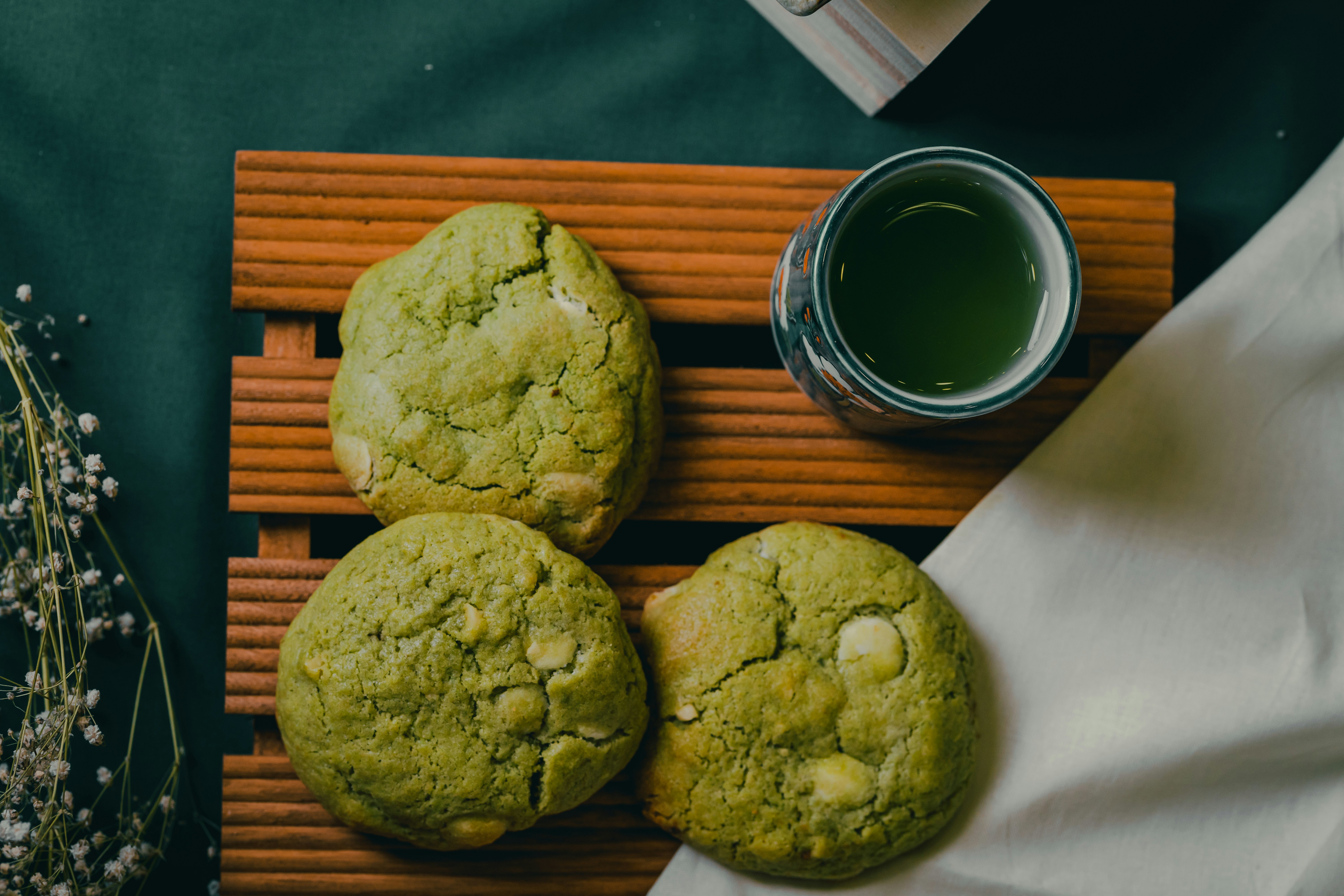 Matcha cookies on a wooden board with matcha tea