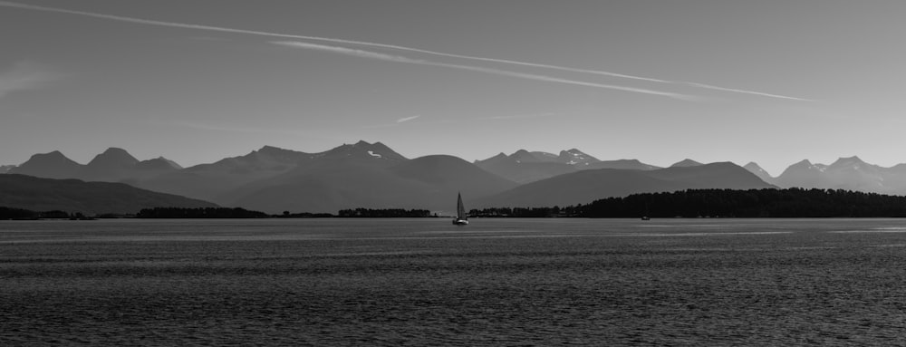 grayscale photo of mountains and body of water