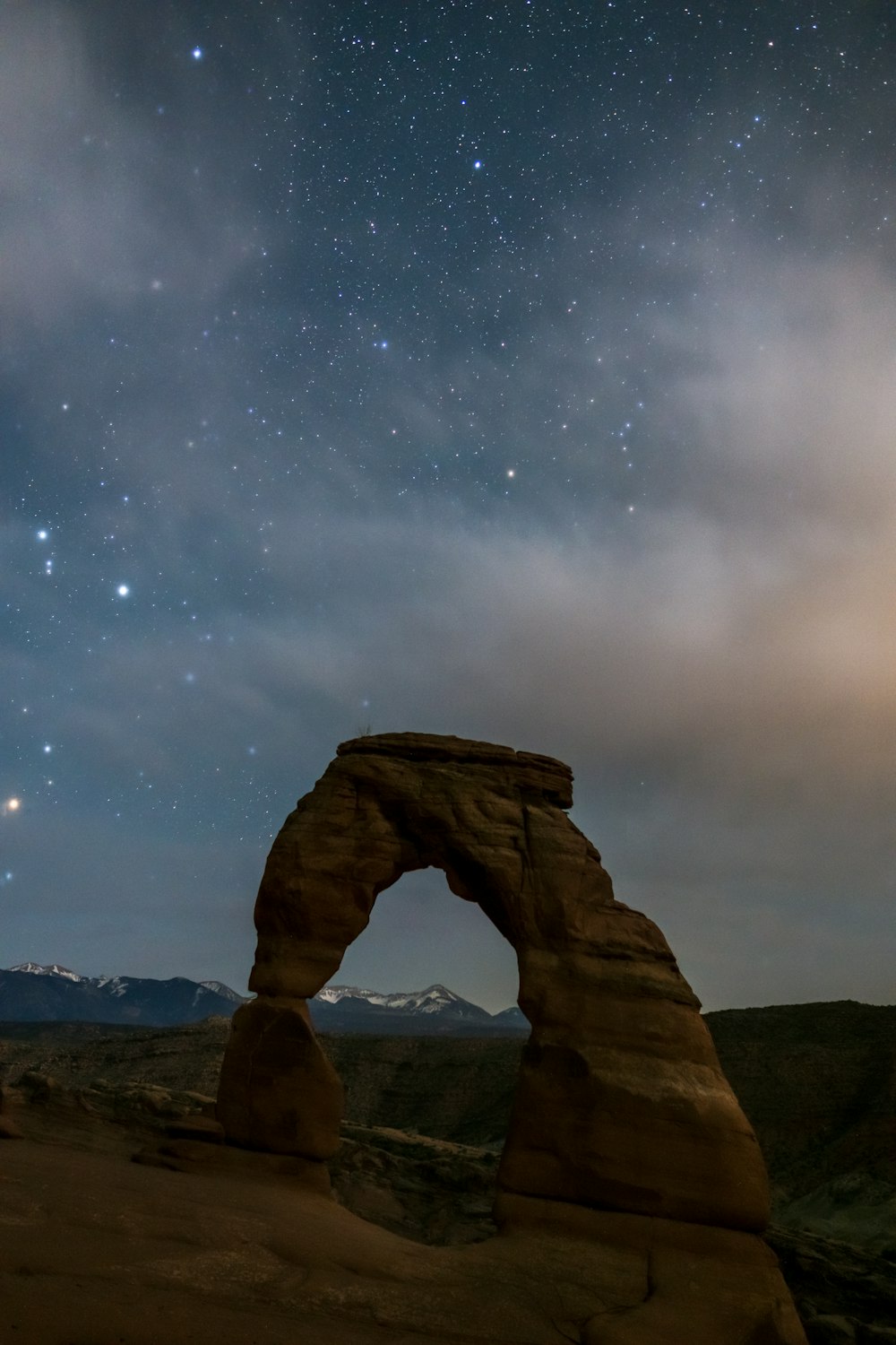 brown rock formation under starry night