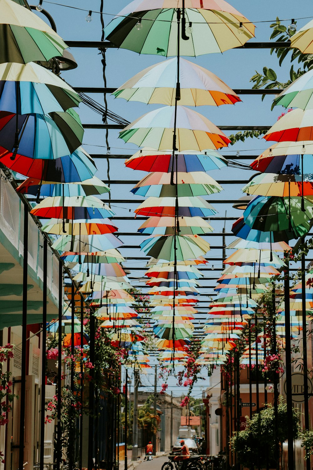 umbrella hanging on metal fence during daytime