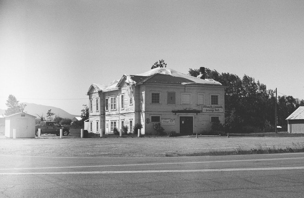 grayscale photo of 2 storey house