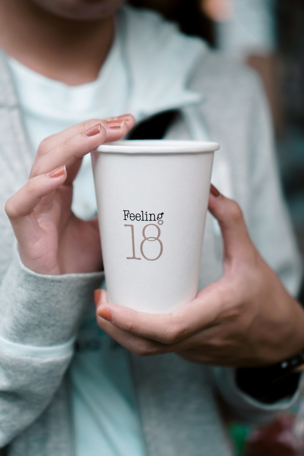 person holding white ceramic mug