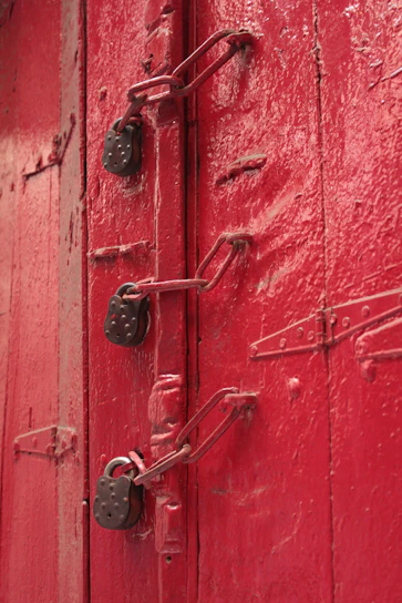 red wooden door with silver padlock